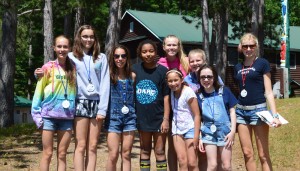 Camp friends by the cabins at WeHaKee Camp for Girls