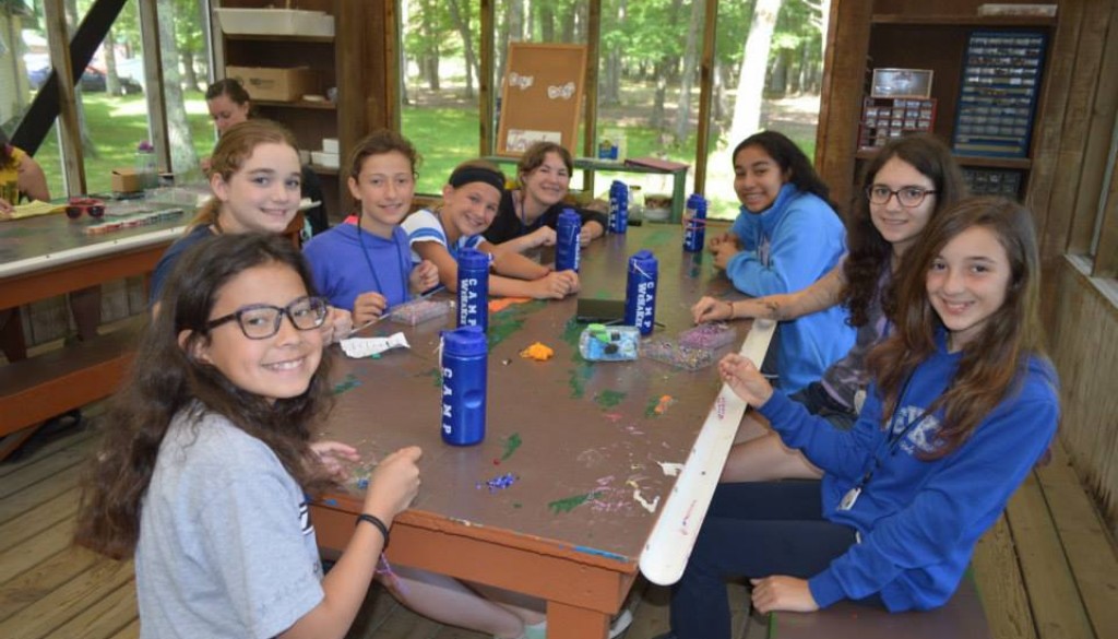 Smiling campers making jewelry