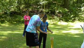 Counselors teaching campers the art of archery at Camp WeHaKee