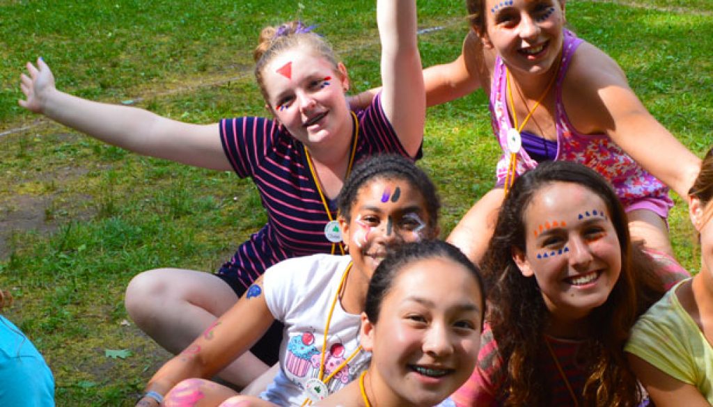 Happy campers with painted faces at WeHaKee Camp for Girls