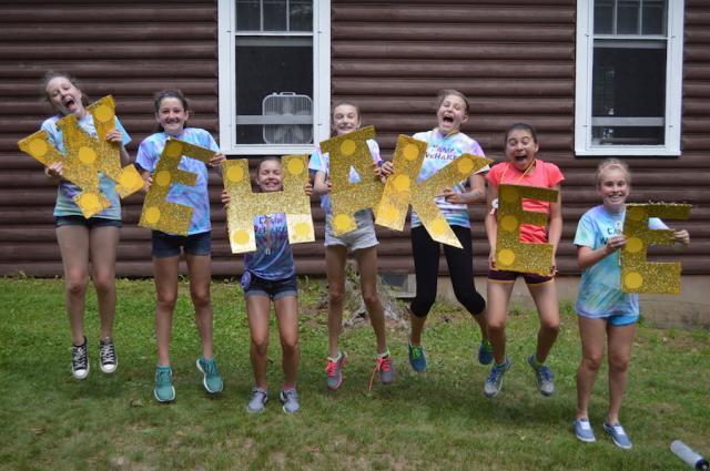 WeHaKee campers holding letters