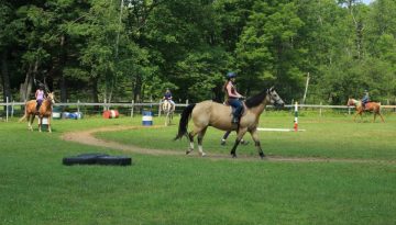 Summer staff horseback riding at WeHaKee Camp for Girls.