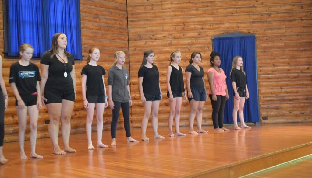 WeHaKee Camp for Girls campers on the cabin stage for a performance.