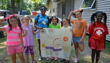 Campers from cabin 6 holding a sign they made at WeHaKee Camp for Girls.