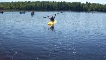 Campers kayaking and canoeing on Hunter Lake.