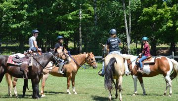 WeHaKee Camp for Girls staff and campers horseback riding.