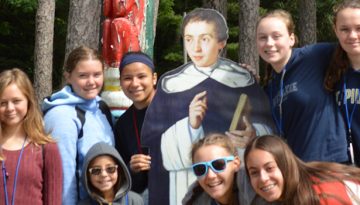 WeHaKee Camp for Girls Campers posing around a cardboard person.