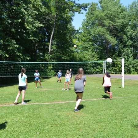 Girls at camp playing volleyball