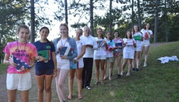 WeHaKee Camp for Girls staff members holding country flags.