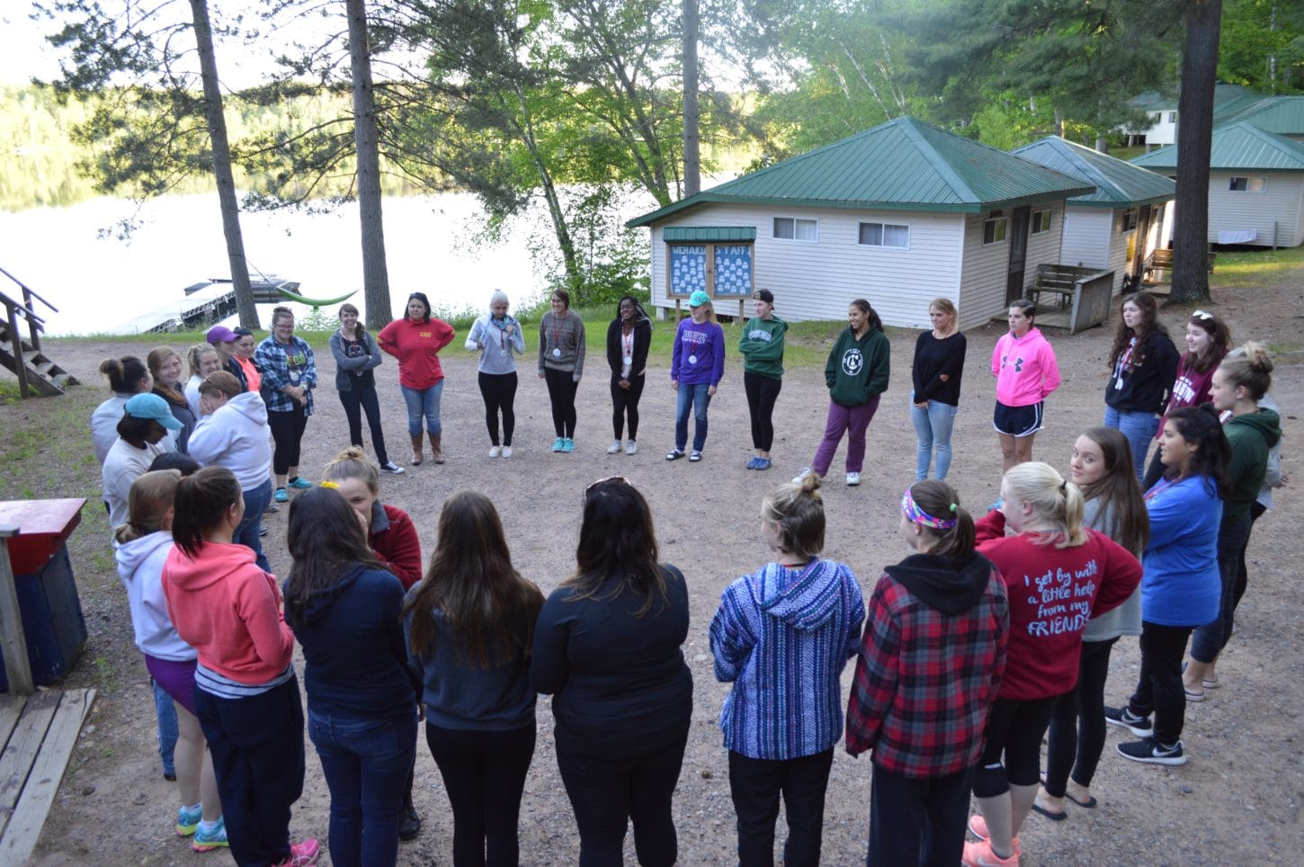 WeHaKee Camp for Girls Campers in a circle playing a game. WeHaKee Camp for Girls Campers in a circle playing a game.