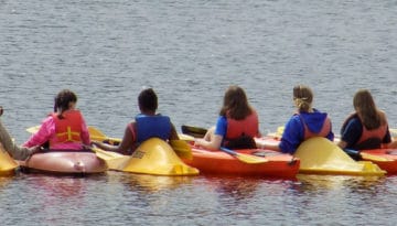 Campers Kayaking on the River at WeHaKee