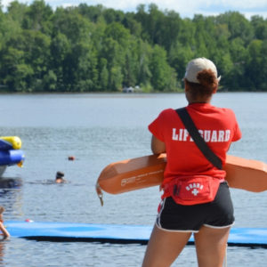 WeHakee Camp for Girls lifeguard staff watching over campers swimming Hunter Lake.