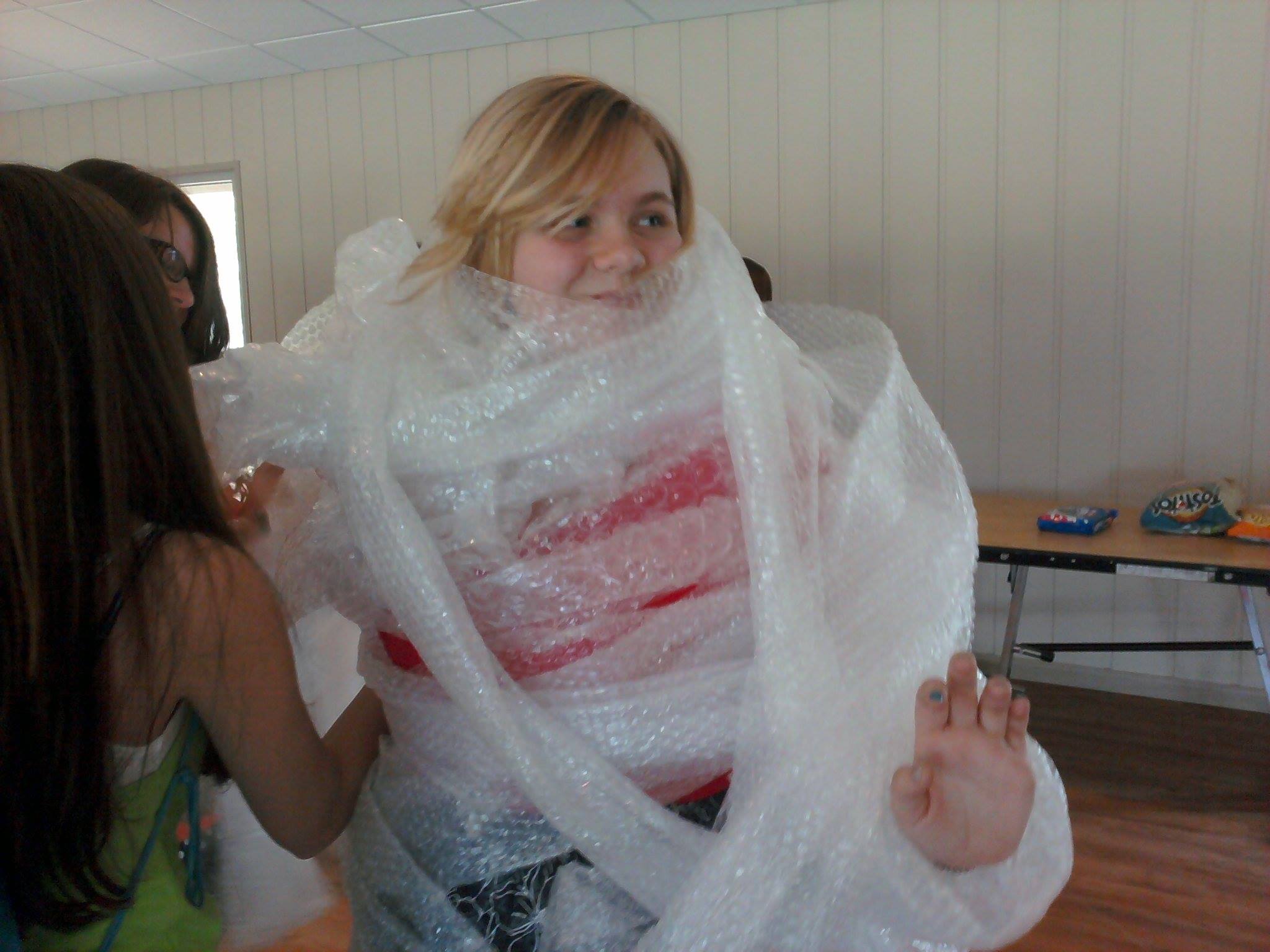 WeHaKee Camp for Girls Staff: Sarah wrapped in bubblewrap.