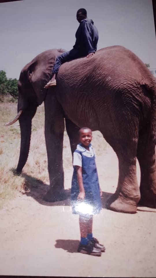 WeHaKee Camp for Girls Staff: Tanaka next to an elephant.