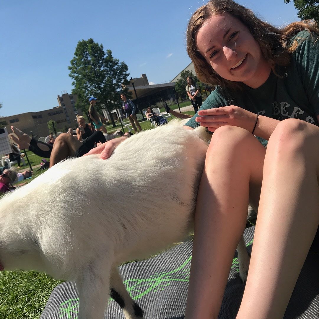 WeHaKee Camp for Girls Staff: Tara petting a goat.