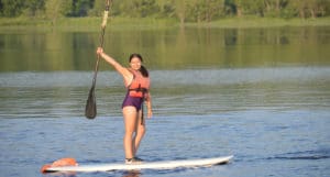 WeHaKee Camp For Girls camper paddle boarding on hunter lake.