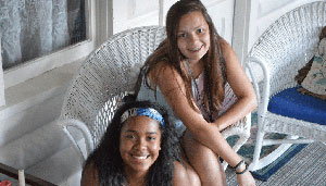 WeHaKee Camp for Girls campers sitting on the porch.