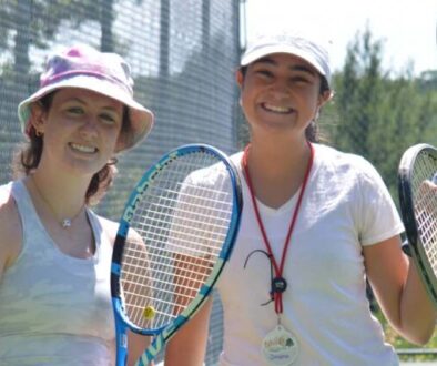 WeHaKee Camp for Girls counselor and three campers holding tennis rackets.