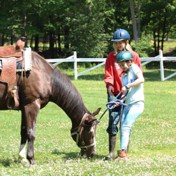 Happy camper and her horse at WeHaKee Camp for Girls