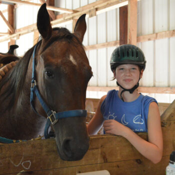 Happy camper and her horse at WeHaKee Camp for Girls