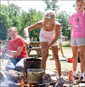 Cooking lunch on the fire pit at WeHaKee Camp for Girls